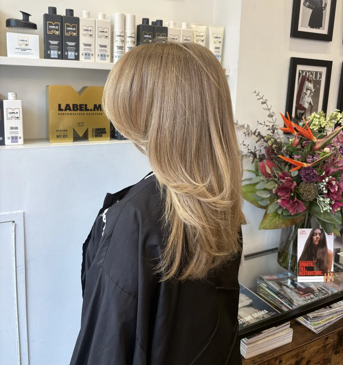 Long honey blonde hair cut in soft face-framing layers
