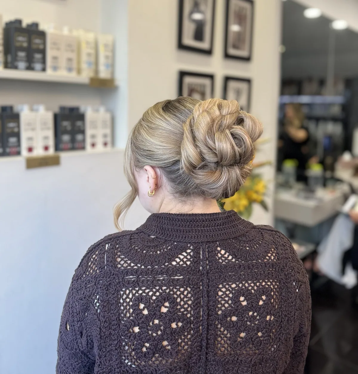 A twisted blonde bun with soft face-framing pieces